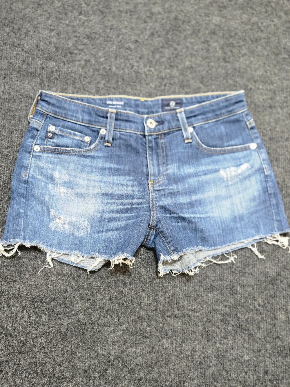 These AG Adriano Goldschmied “The Bonnie” denim cutoff shorts in size 25R delive